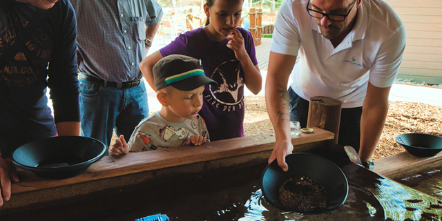 Boy learning gold panning