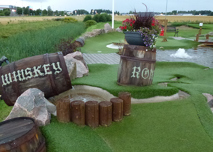 Small fountain of a whiskey barrel at adventure golf