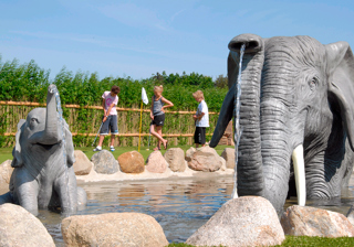 Kids playing Adventure Golf among elephants