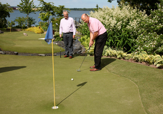 Man aiming at the cup while playing adventure golf
