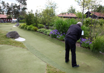 Man playing long Adventure Golf hole