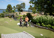 Men standing at adventure golf fairway