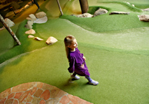 Girl walking across adventure golf fairway