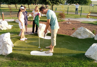 Family playing adventure golf