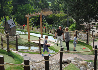 Family playing adventure golf