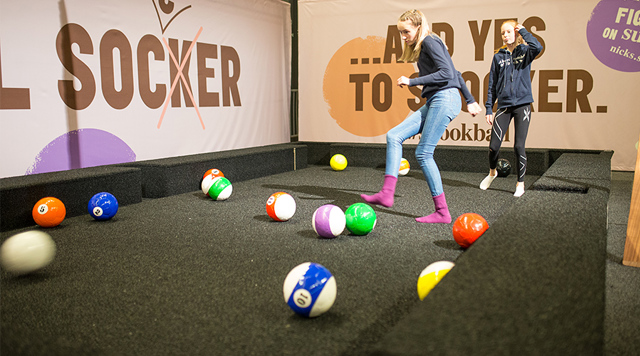 Girls playing soccer billiards