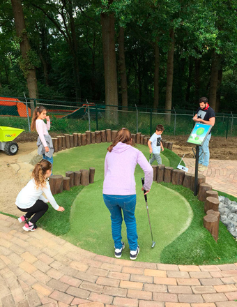 Family playing adventure golf