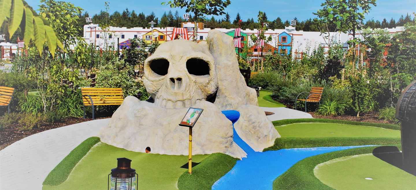 View of the Pirate Adventure Golf course at the LEGOLAND Holiday Village with the 142-room Pirate Island hotel in the background.